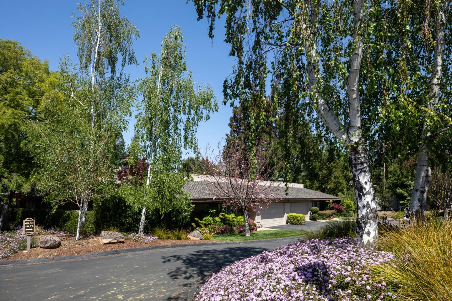 70 Bay Tree Lane Los Altos, CA 94022 - Photo 1 of 37 a view of a street with potted plants and large trees