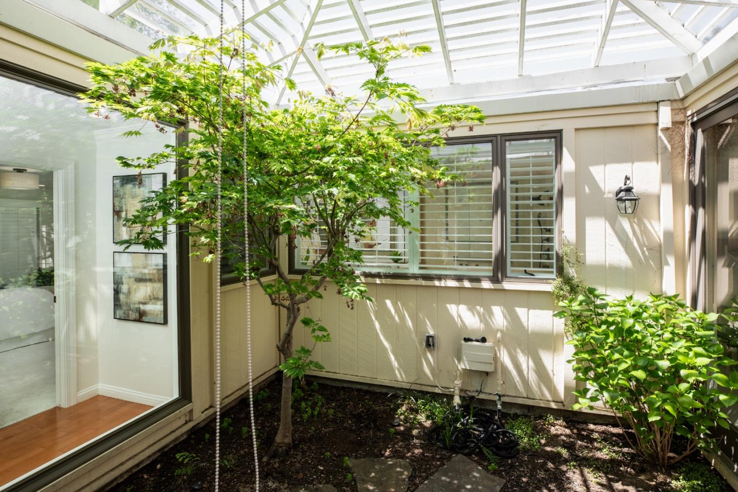 70 Bay Tree Lane Los Altos, CA 94022 - Photo 14 of 37 a front view of a house with a garden