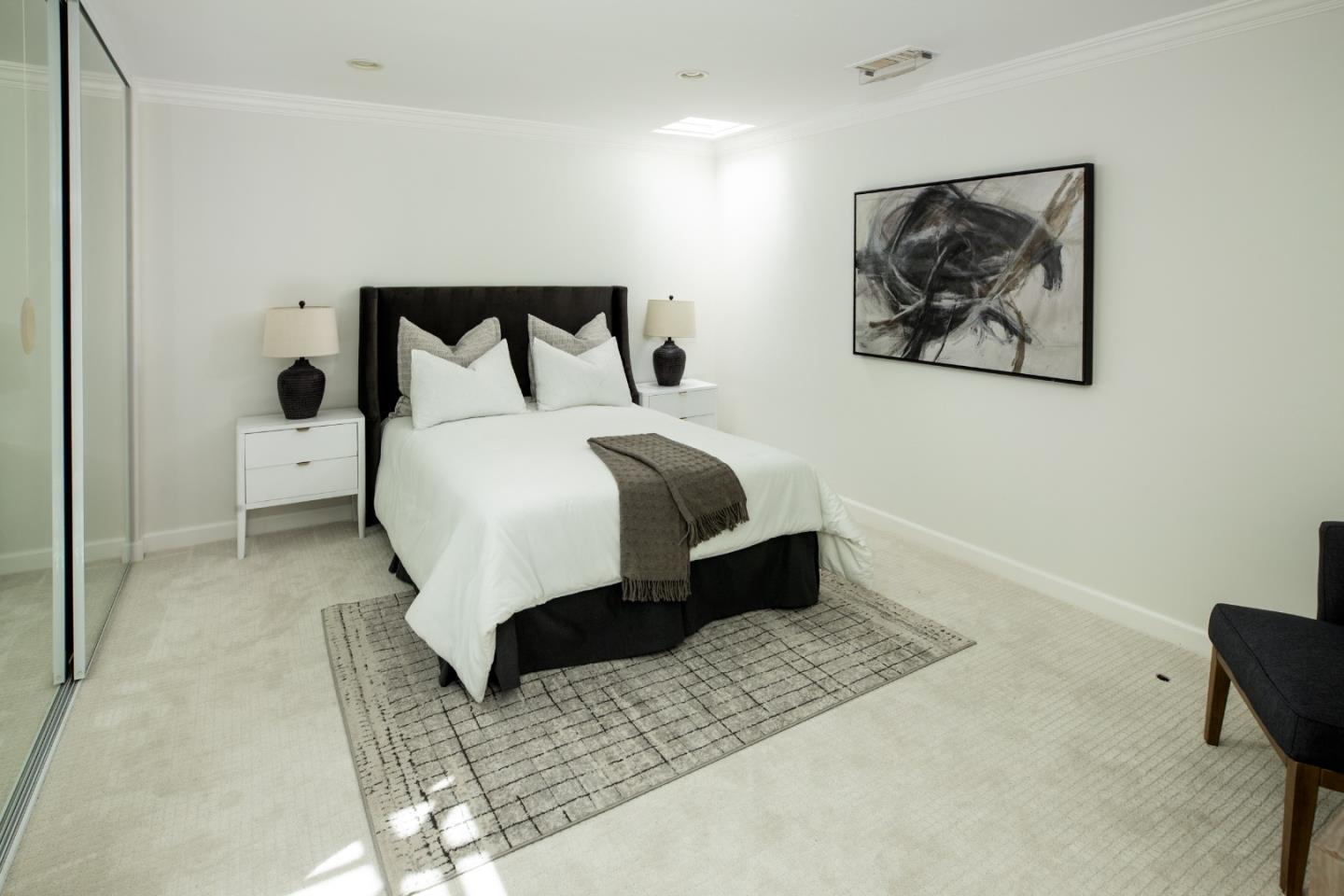 70 Bay Tree Lane Los Altos, CA 94022 - Photo 17 of 37 a bed sitting in a bedroom and painting on the wall