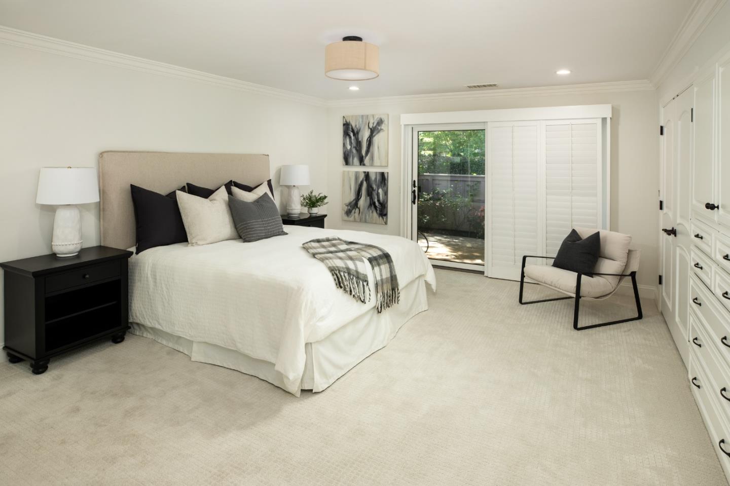 70 Bay Tree Lane Los Altos, CA 94022 - Photo 20 of 37 a spacious bedroom with a bed and lamp