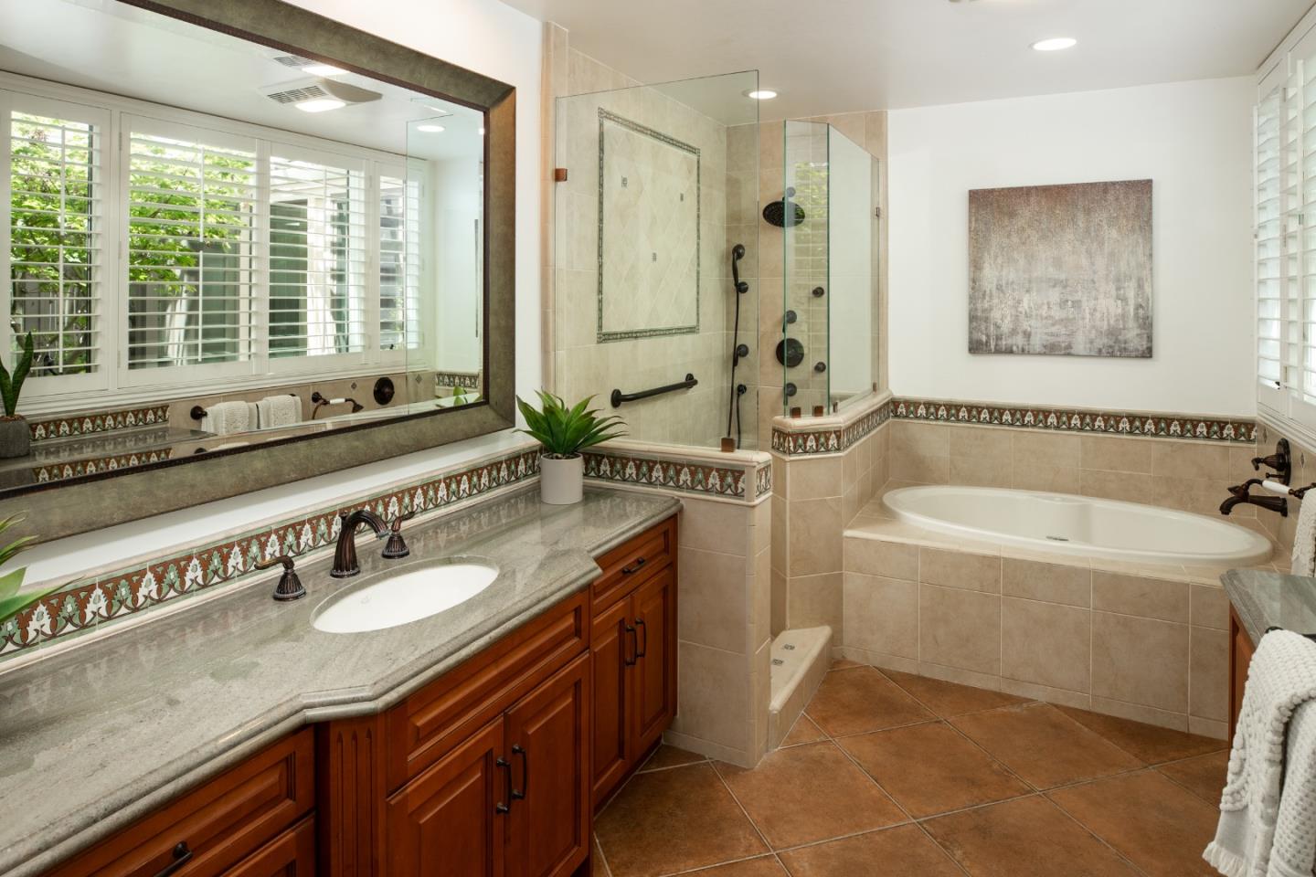 70 Bay Tree Lane Los Altos, CA 94022 - Photo 21 of 37 a bathroom with a granite countertop tub sink a mirror a window and a shower