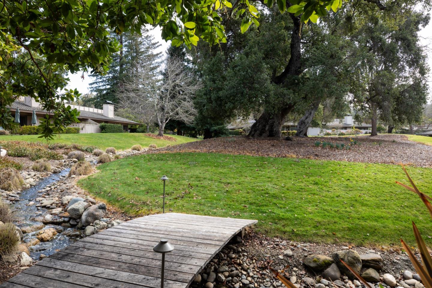 70 Bay Tree Lane Los Altos, CA 94022 - Photo 30 of 37 a view of a backyard with lawn chairs and a fire pit