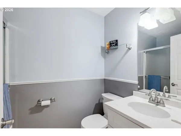 a bathroom with a sink vanity and toilet