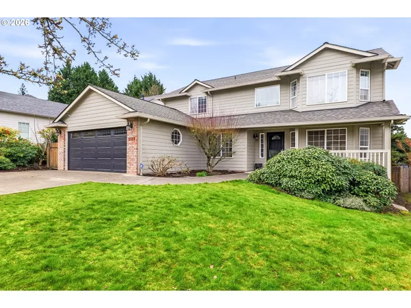 a front view of a house with a garden