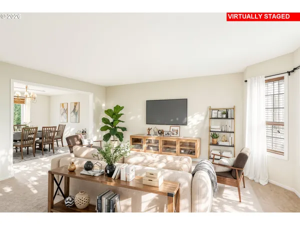 a living room with furniture a flat screen tv and a floor to ceiling window