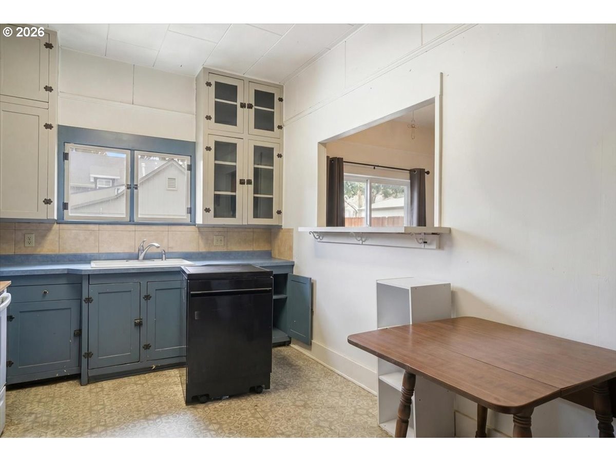 740 South 6th Street Cottage Grove, OR 97424 - Photo 10 of 21 a kitchen with a stove a sink and a refrigerator