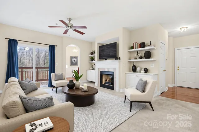 a living room with furniture a fireplace and a flat screen tv