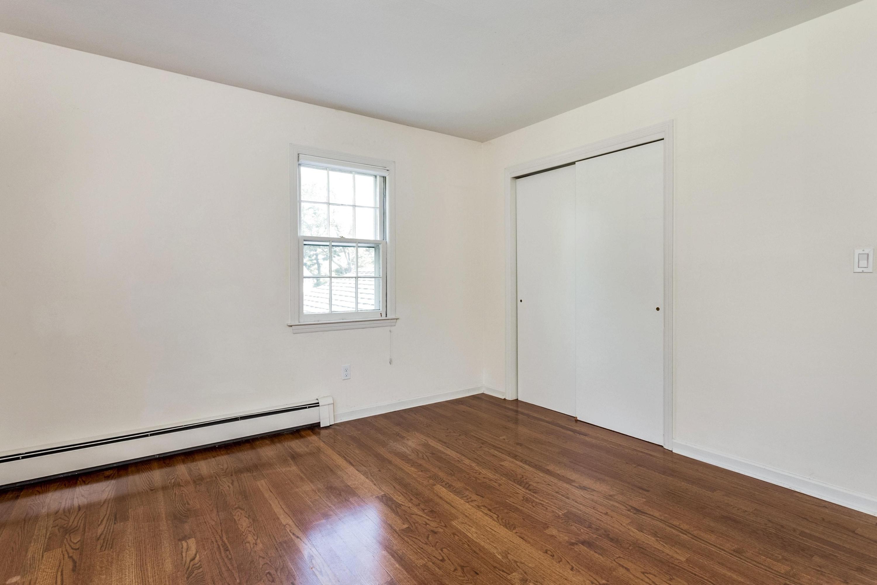1 Wilson Ridge Road Darien, CT 06820 - Photo 14 of 22 an empty room with wooden floor and windows