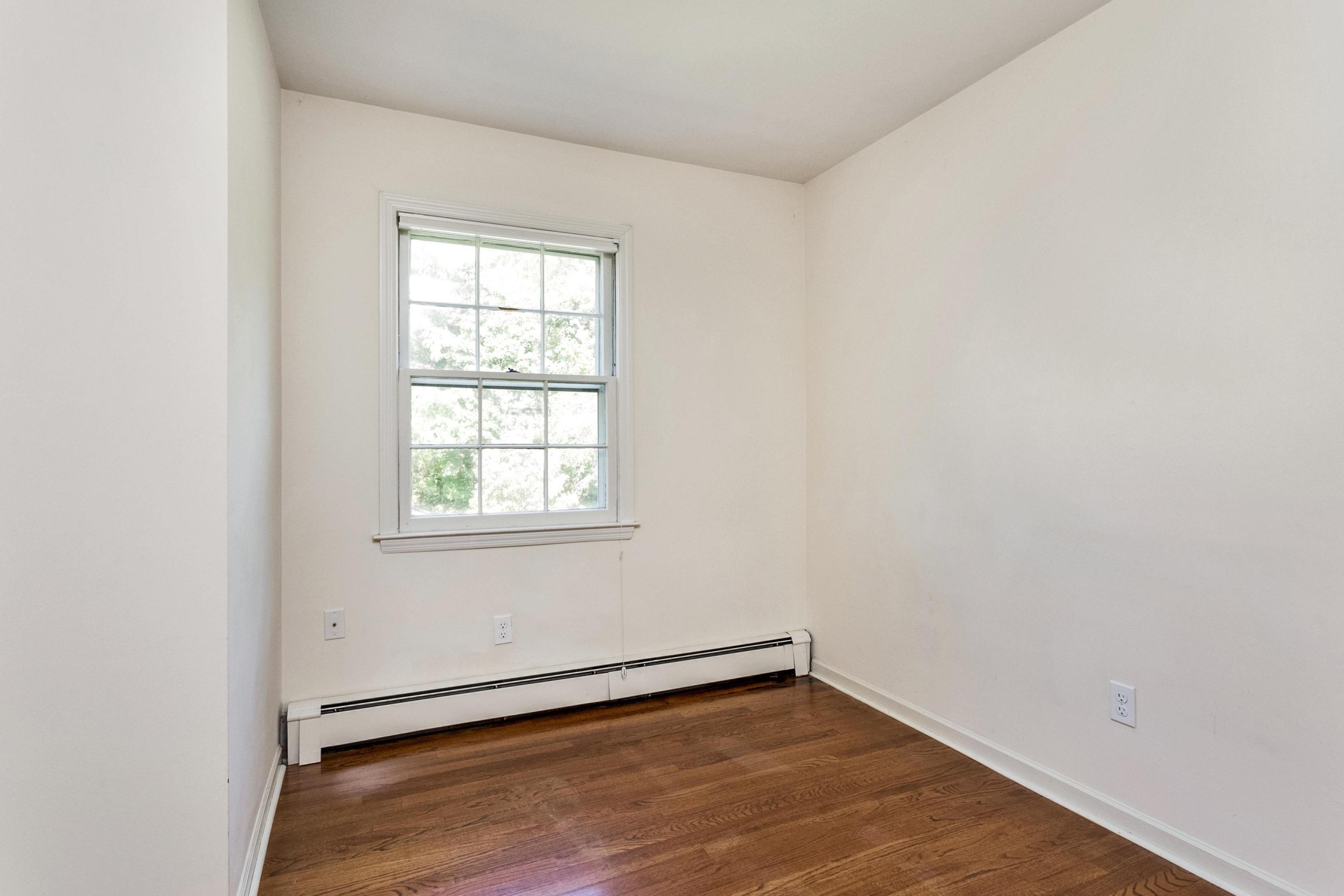 1 Wilson Ridge Road Darien, CT 06820 - Photo 17 of 22 an empty room with wooden floor and windows