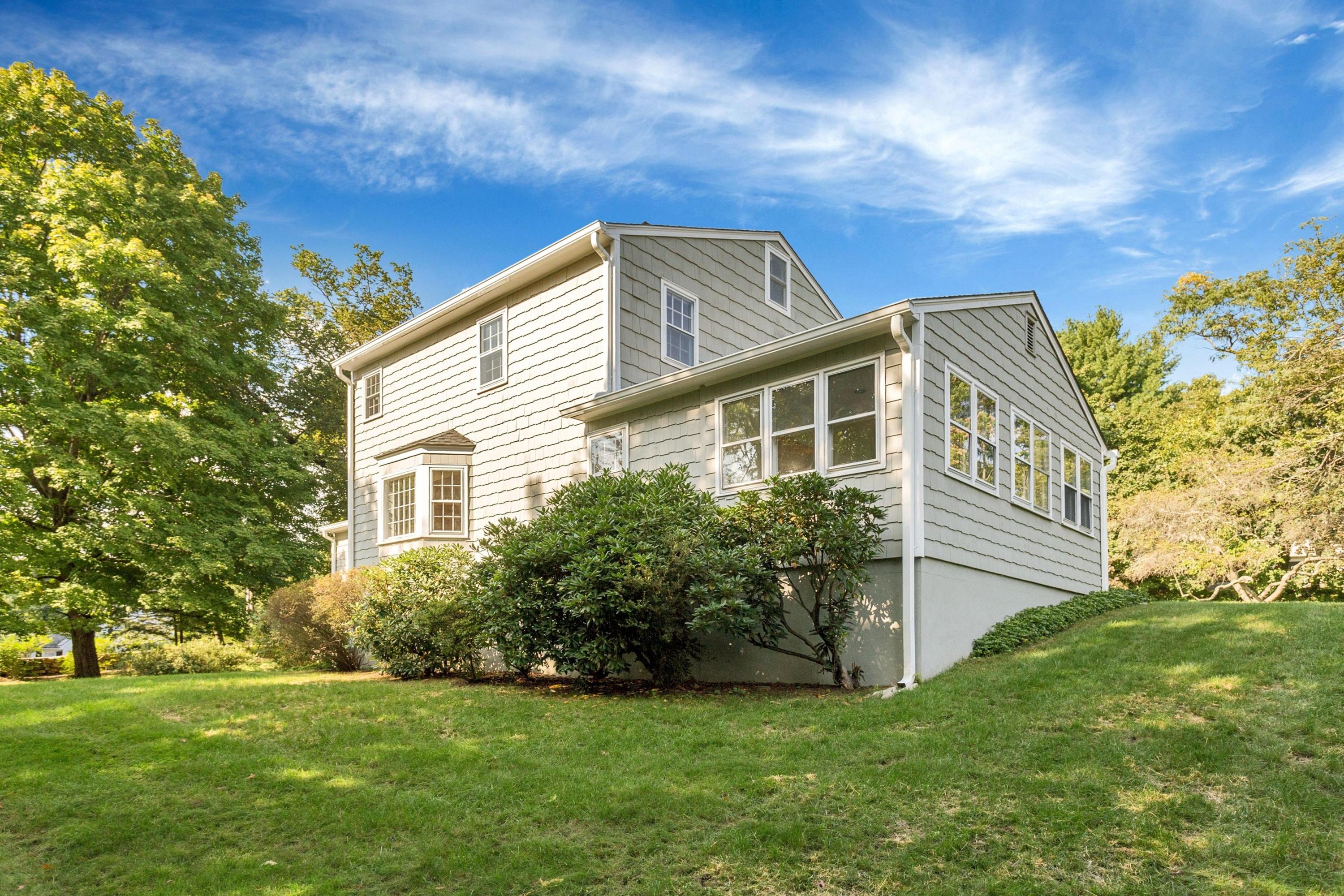 1 Wilson Ridge Road Darien, CT 06820 - Photo 20 of 22 a front view of a house with a garden