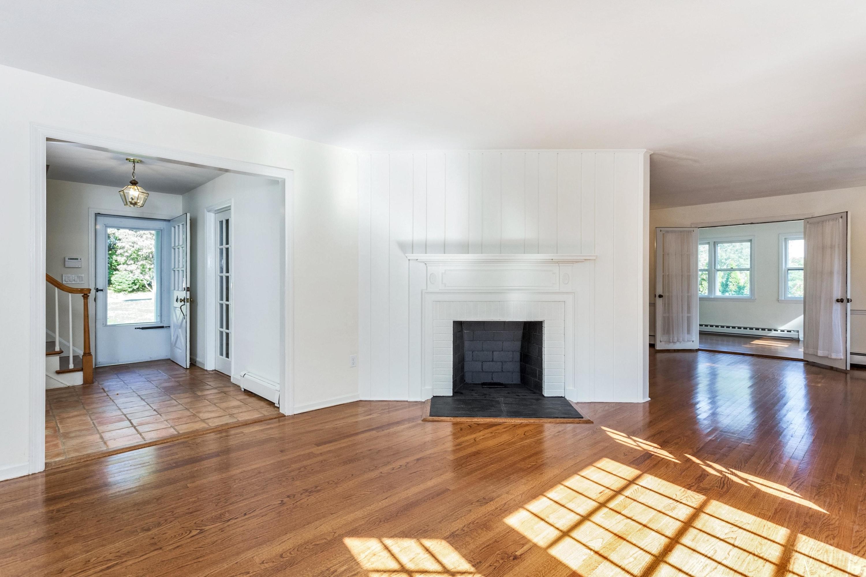 1 Wilson Ridge Road Darien, CT 06820 - Photo 3 of 22 a view of empty room with wooden floor and fireplace