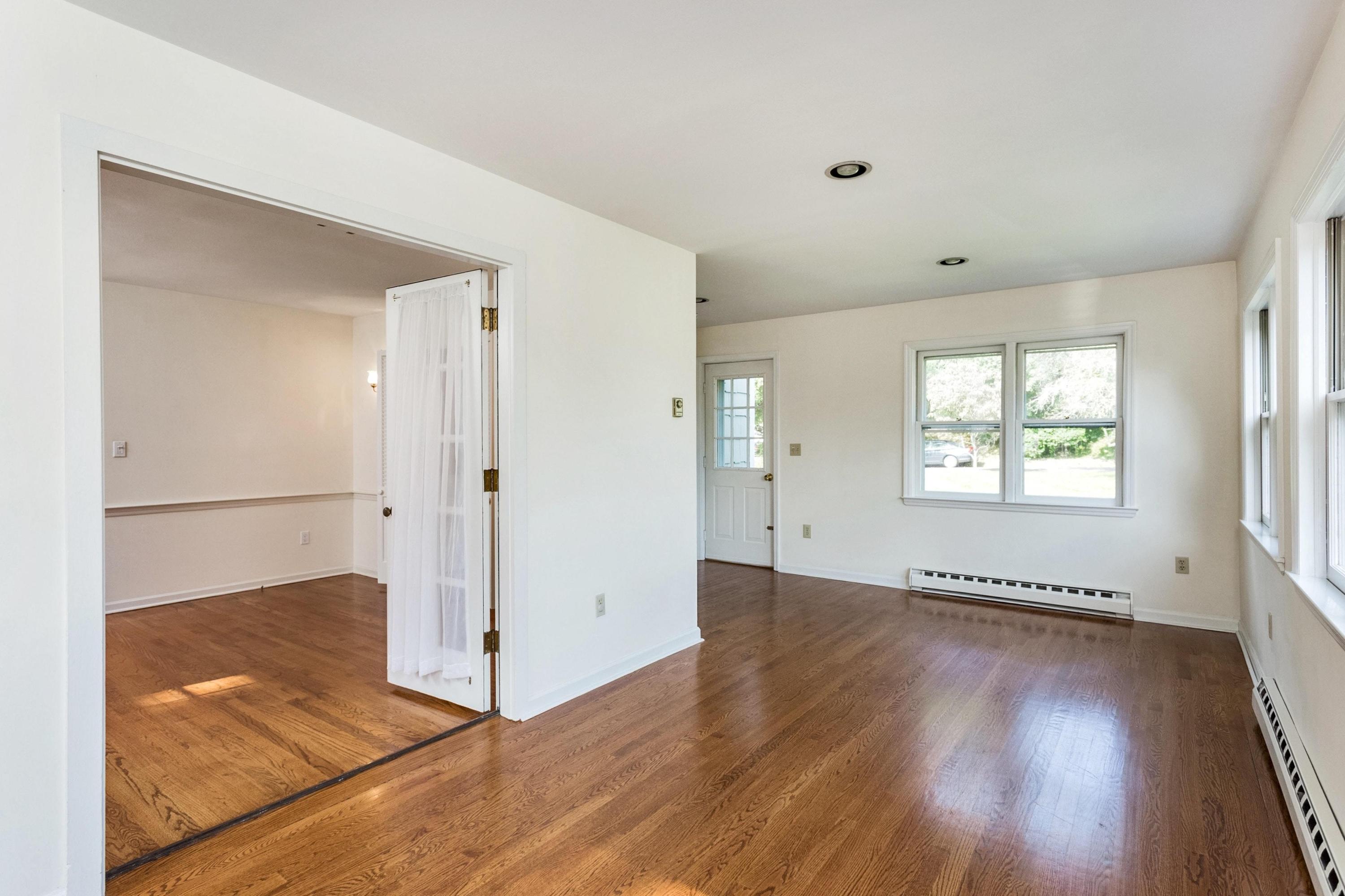 1 Wilson Ridge Road Darien, CT 06820 - Photo 6 of 22 an empty room with wooden floor and windows