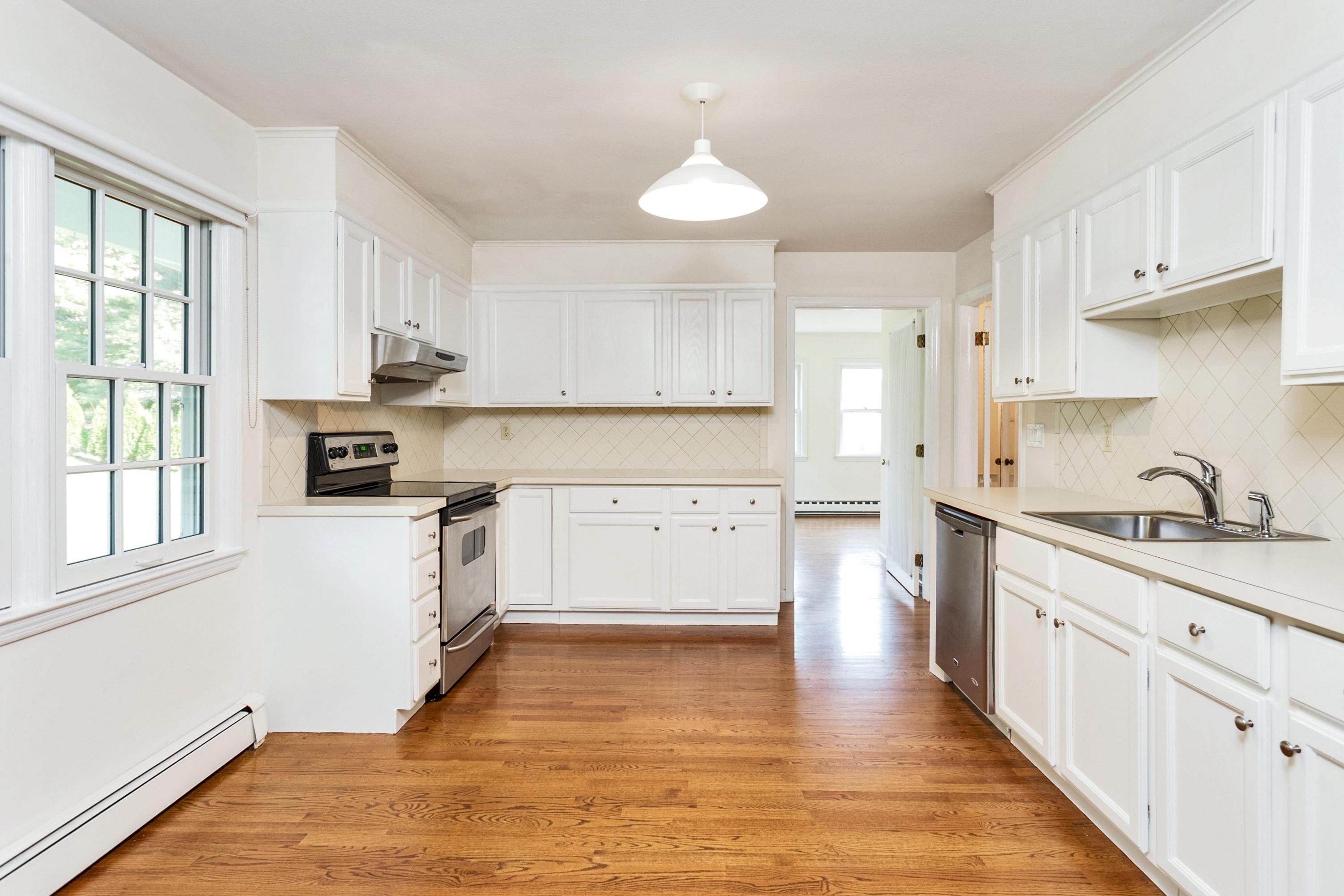1 Wilson Ridge Road Darien, CT 06820 - Photo 8 of 22 a kitchen with stainless steel appliances granite countertop a stove a sink and white cabinets