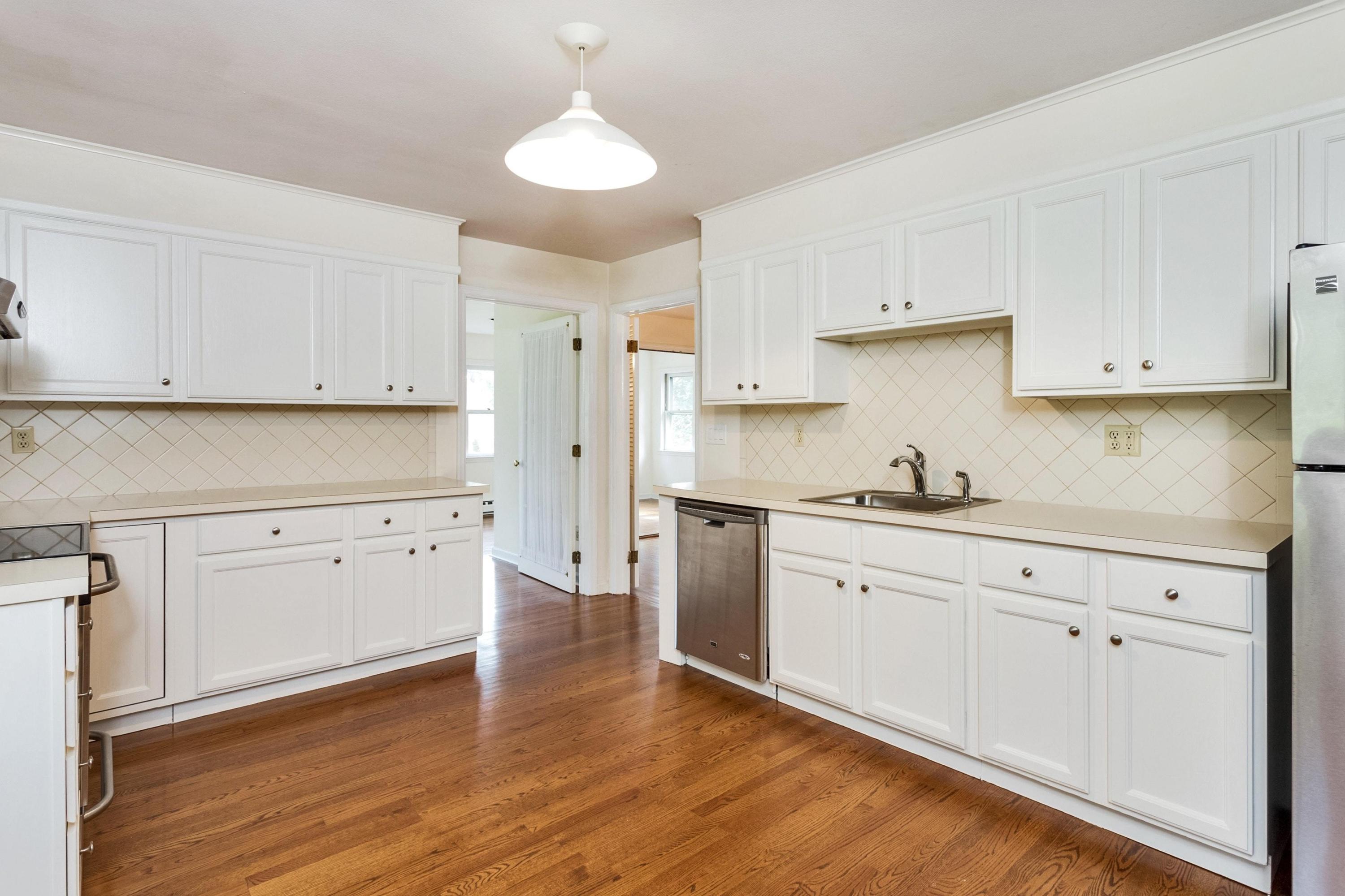 1 Wilson Ridge Road Darien, CT 06820 - Photo 9 of 22 a kitchen with granite countertop white cabinets white stainless steel appliances with a sink and dishwasher