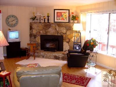 53835 Tollgate Road Idyllwild, CA 92549 - Photo 3 of 11 a living room with furniture a flat screen tv and a fireplace