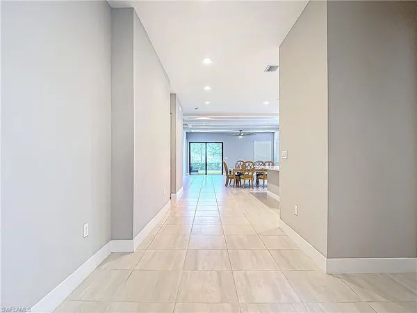 a view of hallway with livingroom and furniture
