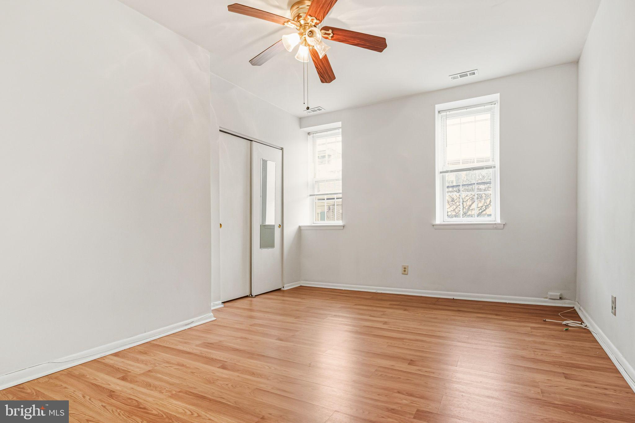 788 South 2nd Street, Unit 2 Philadelphia, PA 19147 - Photo 5 of 11 an empty room with wooden floor chandelier fan and windows