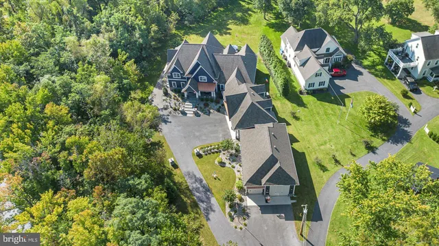 a view of a patio with table and chairs potted plants and a barbeque