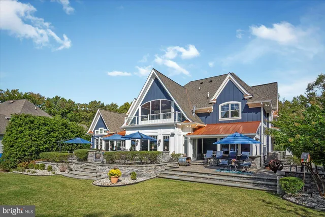 a view of a house with a yard patio and sitting area