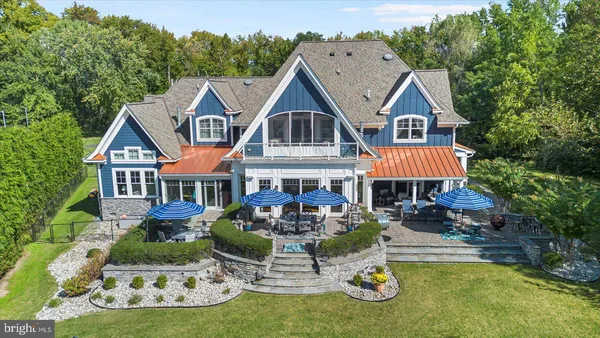 a view of a patio with couches dining table and chairs with wooden floor