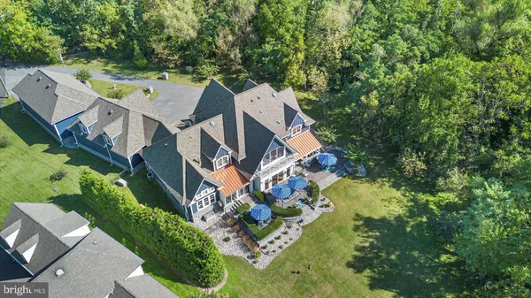 an aerial view of a house with a yard