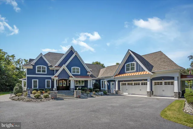 a front view of a house with yard and parking