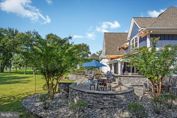 a living room with furniture a fireplace and a ceiling fan