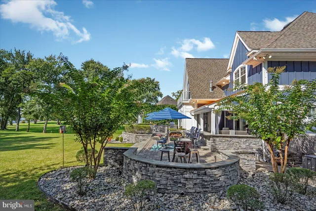 a living room with furniture a fireplace and a ceiling fan