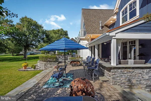 a kitchen with stainless steel appliances granite countertop a kitchen island hardwood floor sink and stove