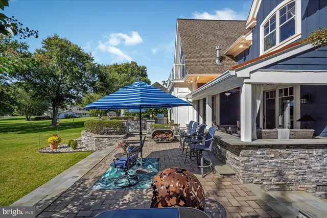 a kitchen with stainless steel appliances granite countertop a kitchen island hardwood floor sink and stove