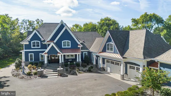 a front view of a house with a garden and yard