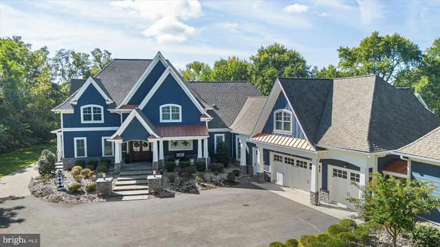 a front view of a house with a garden and yard