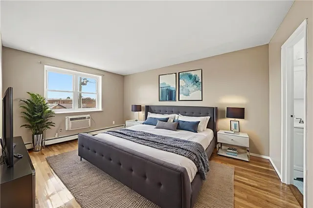 a spacious bedroom with a large bed and a window