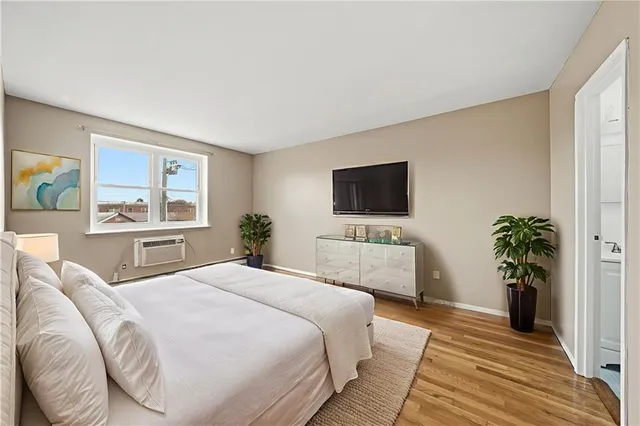 a bedroom with a large bed and a flat screen television