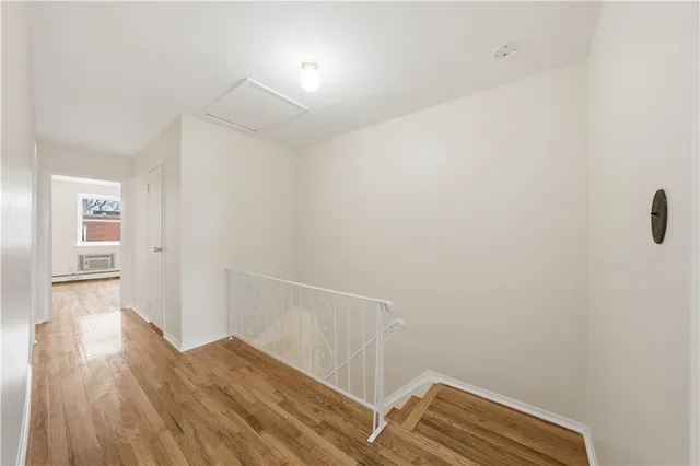 a view of hallway with wooden floor