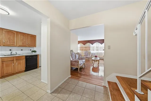 a kitchen with stainless steel appliances a stove a sink and a refrigerator with white cabinets