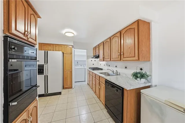 a kitchen with a sink refrigerator and microwave