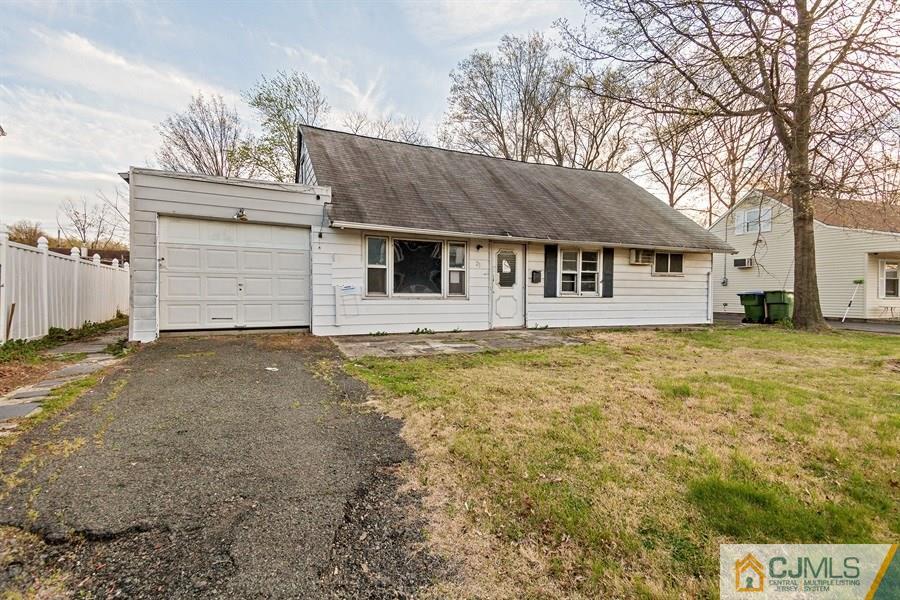 25 Brookville Road Edison, NJ 08817 - Photo 1 of 11 a house that has a tree in front of it