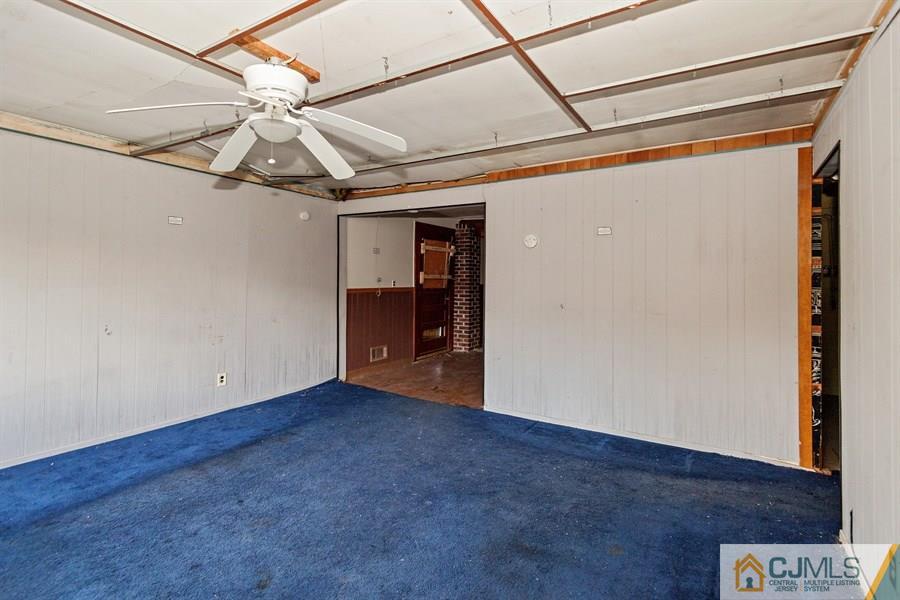 25 Brookville Road Edison, NJ 08817 - Photo 4 of 11 a view of a room with wooden floor and a ceiling fan