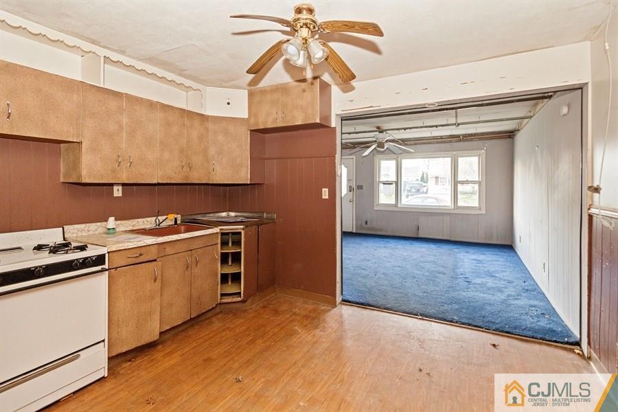 25 Brookville Road Edison, NJ 08817 - Photo 6 of 11 a kitchen with a sink cabinets stainless steel appliances and a counter top space