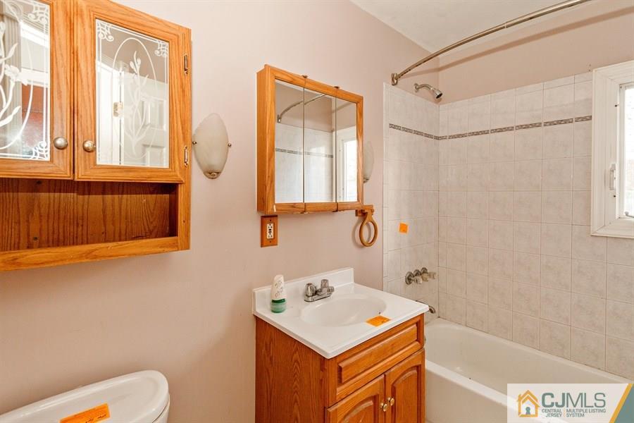 25 Brookville Road Edison, NJ 08817 - Photo 7 of 11 a bathroom with a sink a toilet and a shower
