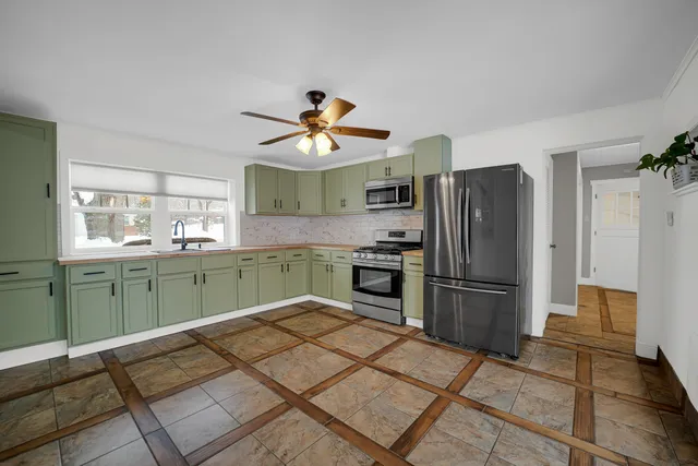 a kitchen with a refrigerator and a sink