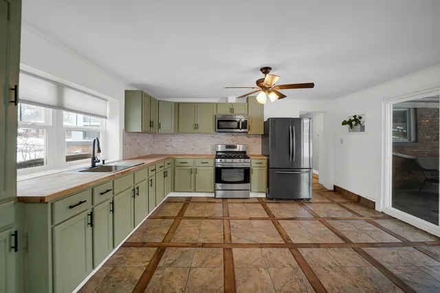 a kitchen with a sink a counter and stainless steel appliances