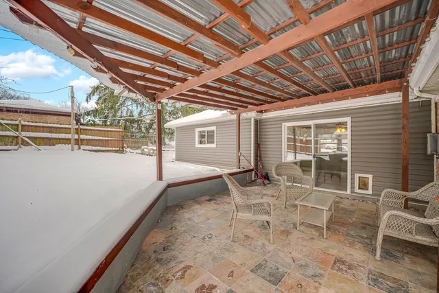 a view of a chairs and table in the patio