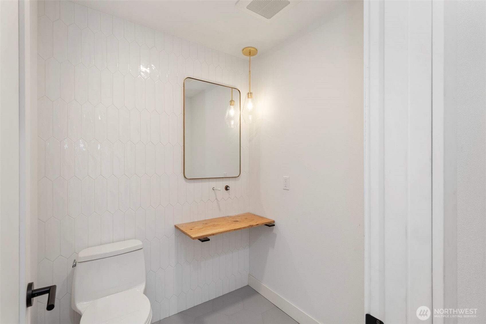 16455 Agate Point Road Northeast Bainbridge Island, WA 98110 - Photo 12 of 26 a bathroom with a toilet sink and mirror