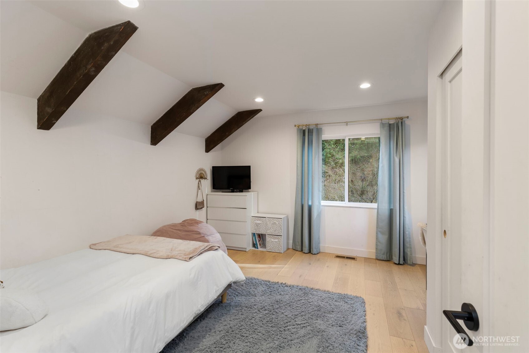 16455 Agate Point Road Northeast Bainbridge Island, WA 98110 - Photo 20 of 26 a bedroom with a large bed and a window