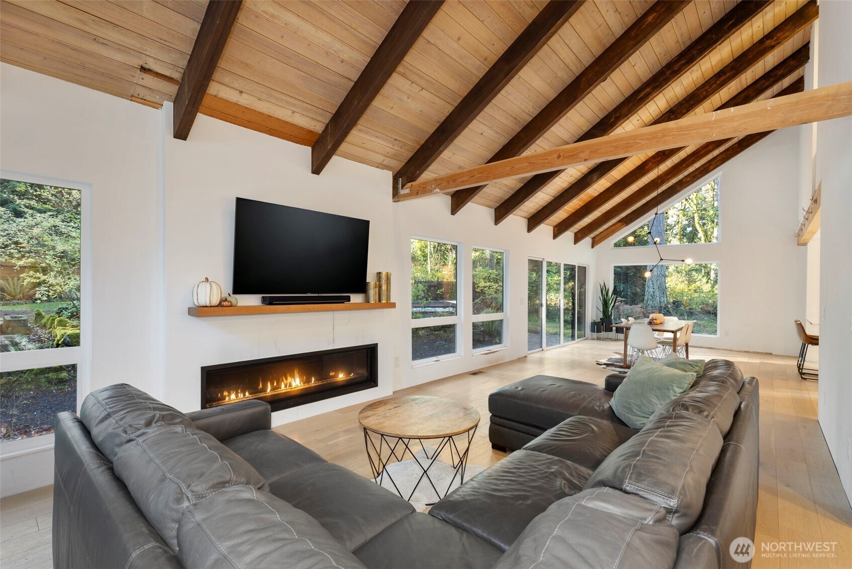16455 Agate Point Road Northeast Bainbridge Island, WA 98110 - Photo 4 of 26 a living room with fireplace furniture and a flat screen tv