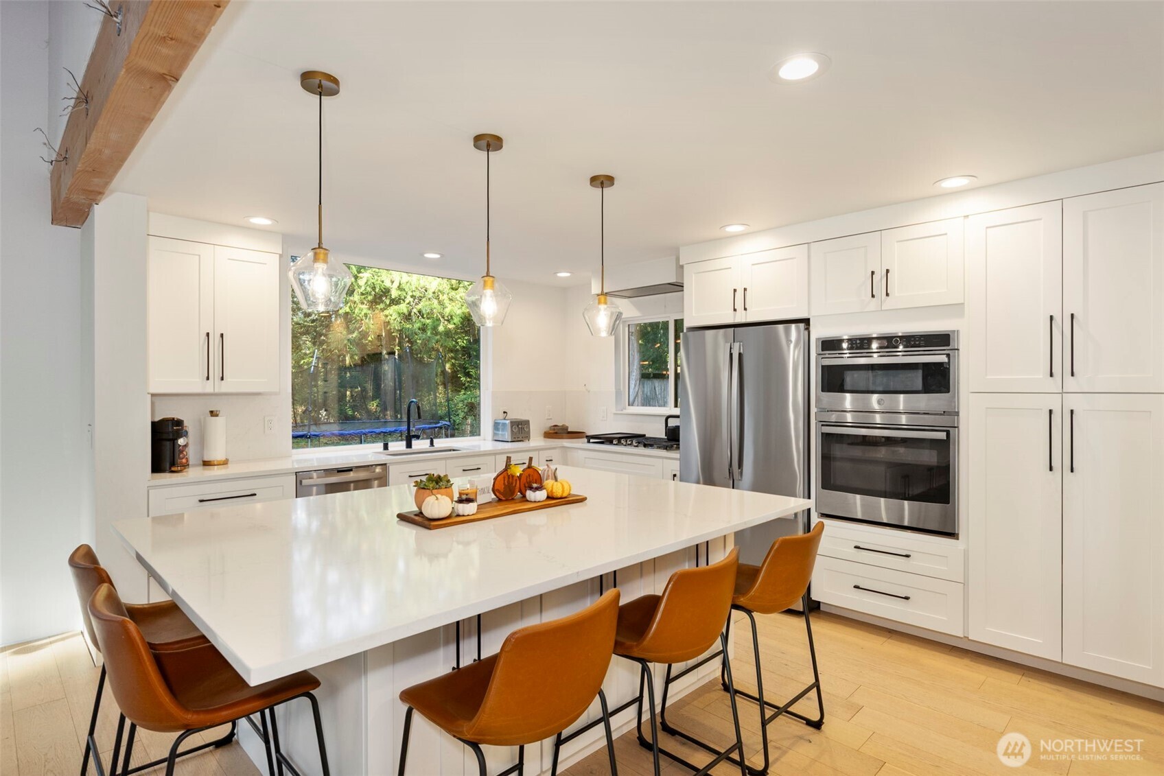 16455 Agate Point Road Northeast Bainbridge Island, WA 98110 - Photo 8 of 26 a kitchen with a table chairs and refrigerator