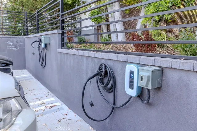 a view of a chair and table in backyard of the house