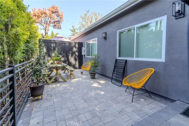 an outdoor space with furniture and umbrella